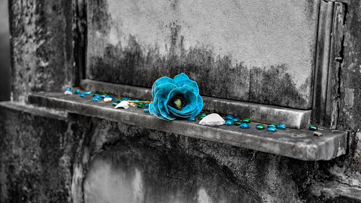 Flower and glass stones on tomb