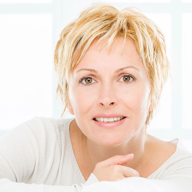 confidant woman with short blonde hair smiling into the camera