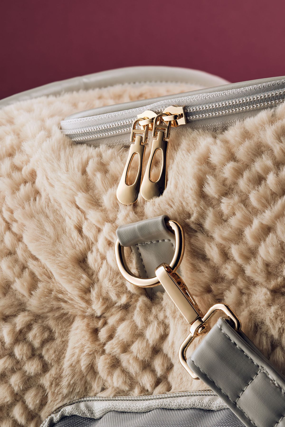 Close up detail of the gold colored hardware on a pet carrier.