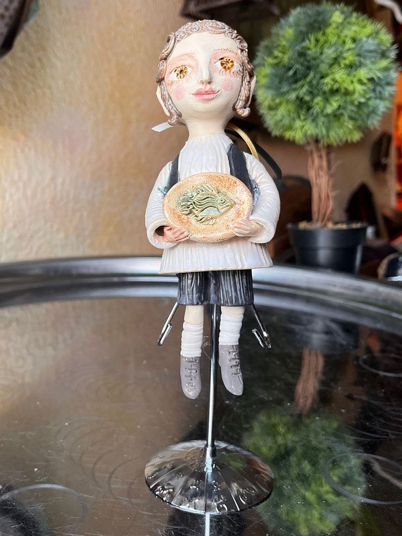 Traditional boy with a fish, little ceramic hanging sculpture