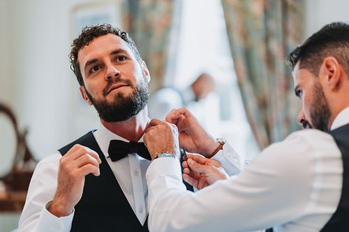 Groom and best mad getting ready