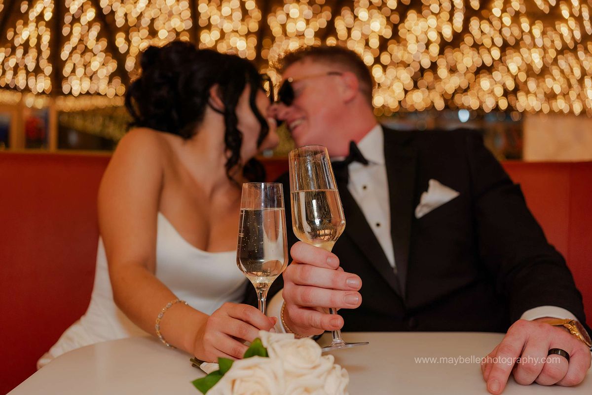 Romantic elopement photos at Carousel Bar in Downtown Las Vegas with couple celebrating with champagne