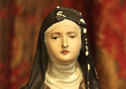 A small St. Therese Statue from St. Leo Oratory's vestibule in bad need of restoration.  Close-up of the face