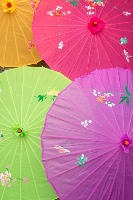 An orange, fuchsia, green and purple parasol