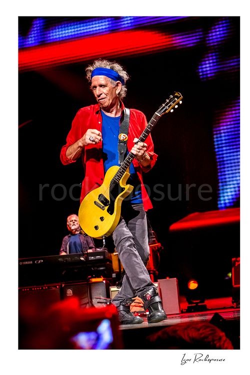 Vertical color image of Keith Richards of The Rolling Stones performing live with electric guitar on stage