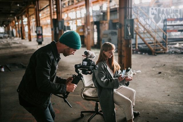 Photographer filming a model