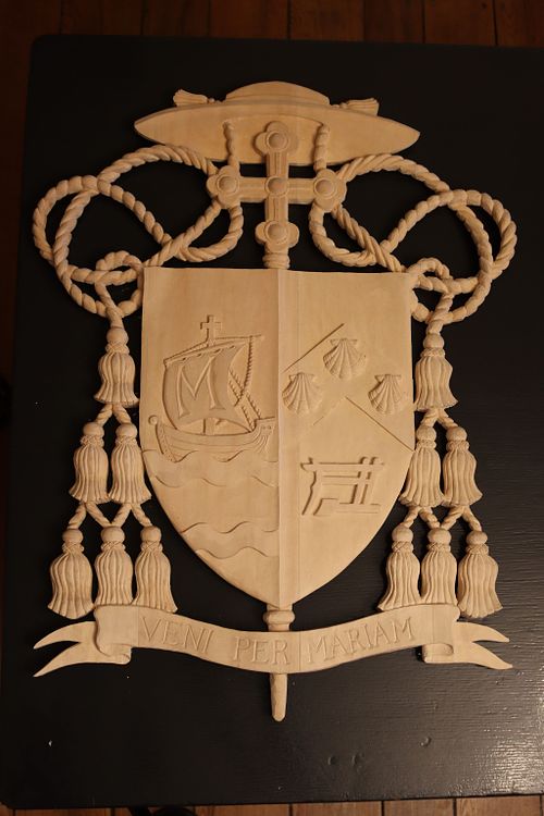 carved coat of arms prepped for paint