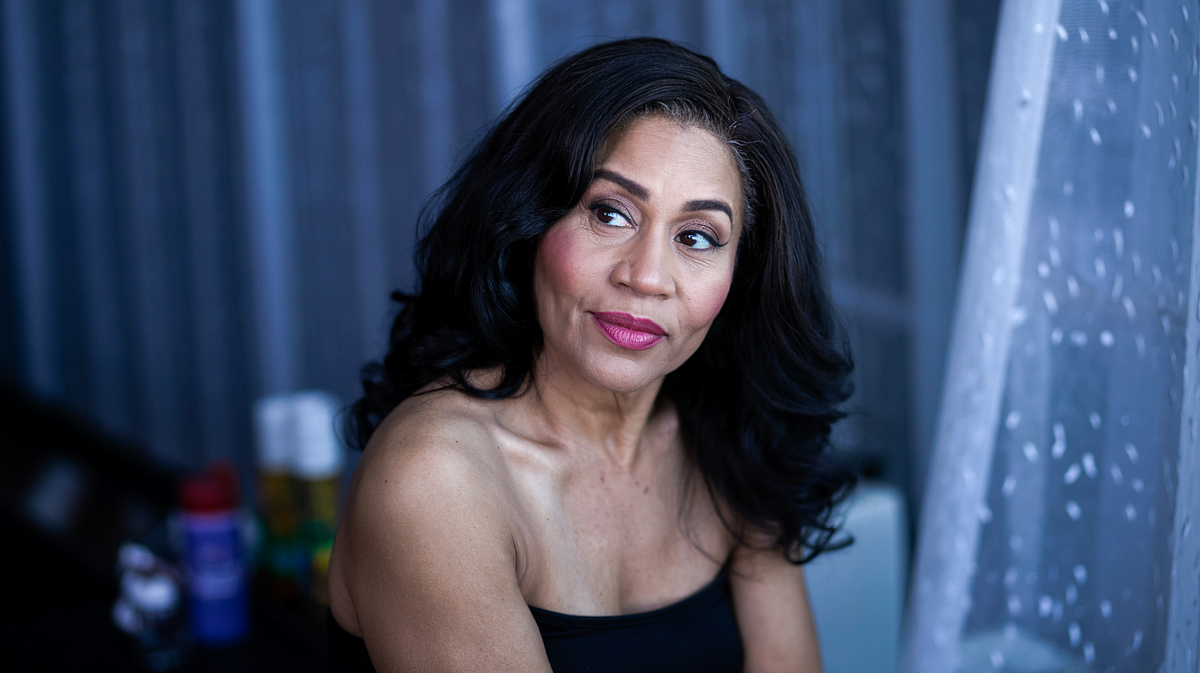 Empowering boudoir portrait with confident pose and soft lighting