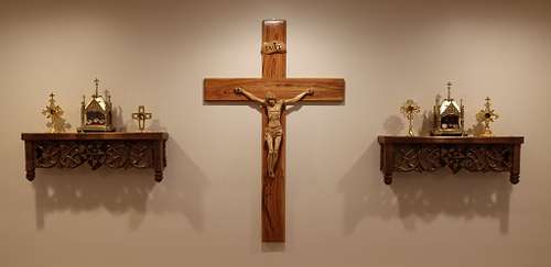 the shelves with the reliquaries on them flanking the crucifix at the back of the chapel