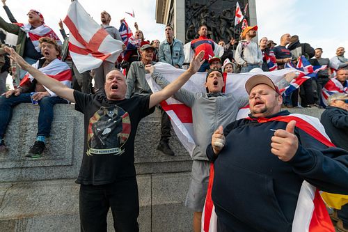Protesters climb Trafalgar Square plinth during “Unite the Kingdom” rally, London, UK