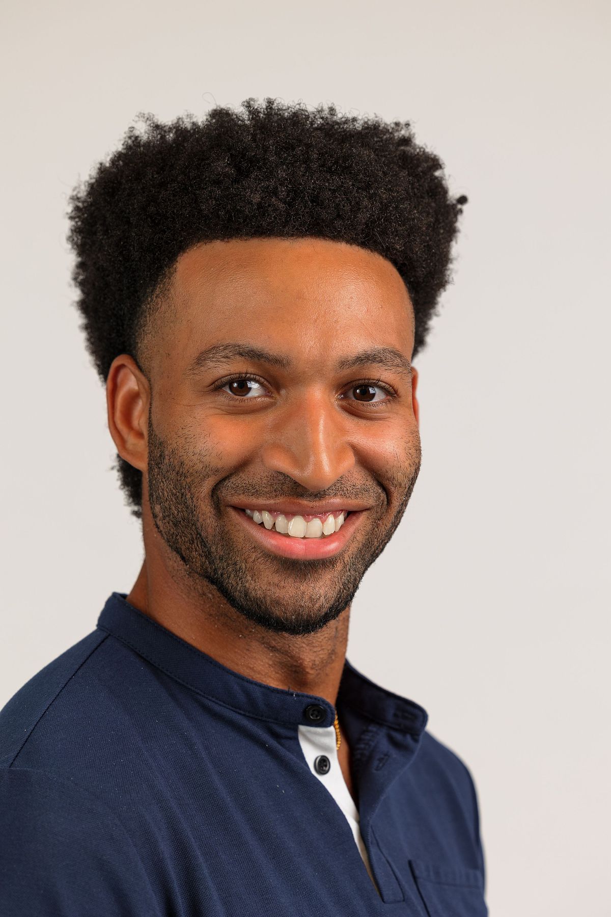 A man's close-up headshot against a white backdrop at Innovate Carolina's offices in Chapel Hill, NC
