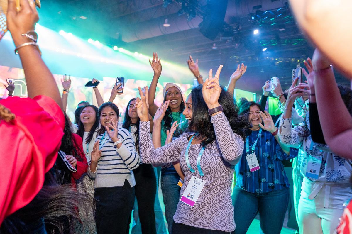 Corporate event photography capturing Grace Hopper Celebration attendees dancing and celebrating during an after-hours event in Philadelphia, highlighting joy, community, and connection.