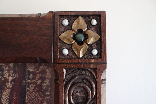 detail of a virgin's bower flower with polychrome painting and white beads around it