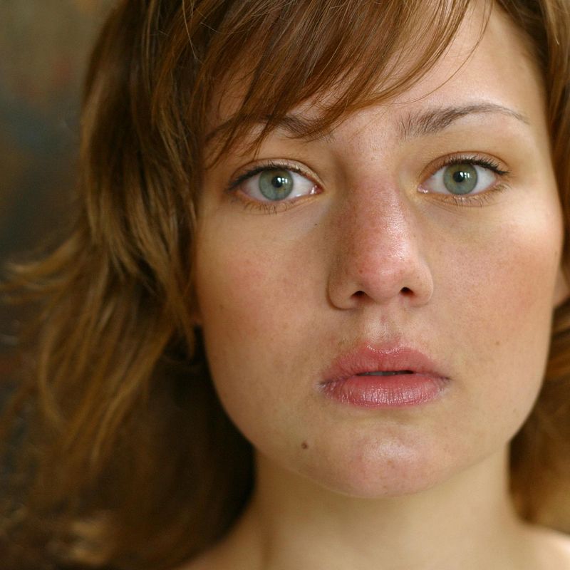 worried and confused looking woman looking into camera