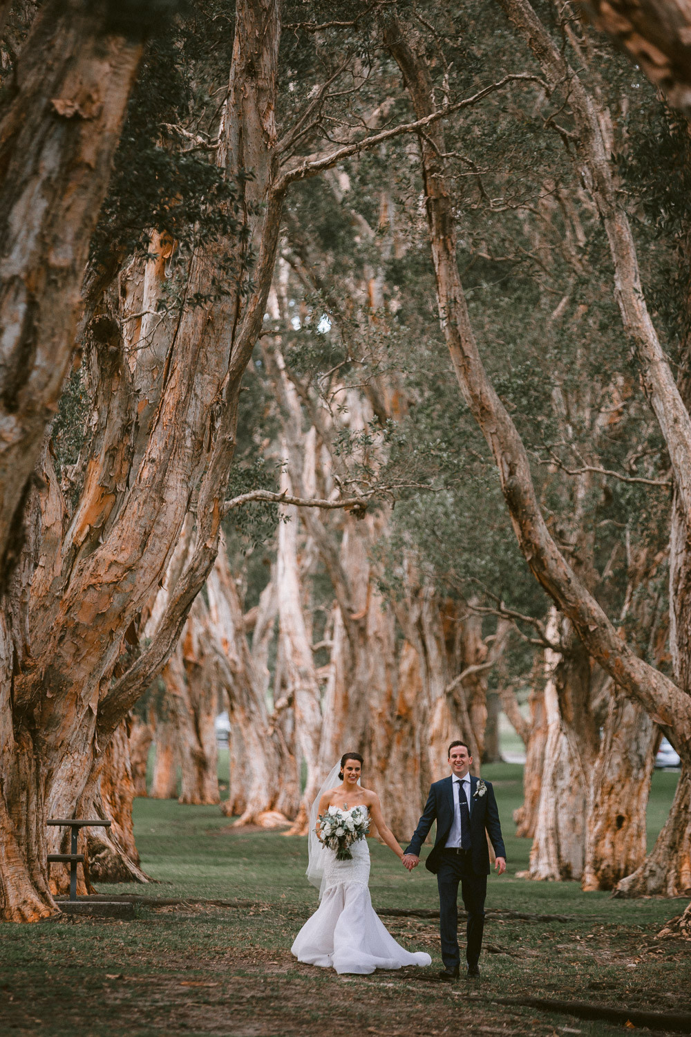 Joyful wedding photo of the newlyweds at Centennial Park.