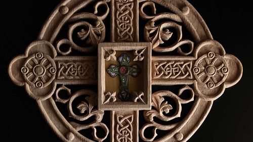 Close up picture of the carving on the reliquary and the relic itself.
