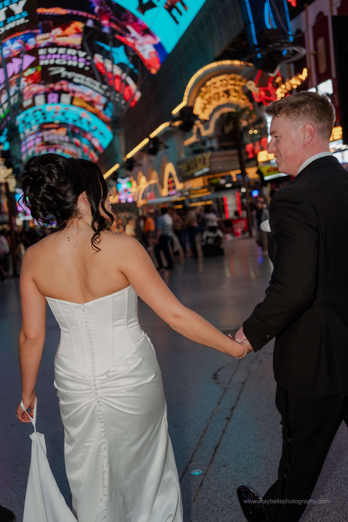 Romantic elopement photos at Carousel Bar in Downtown Las Vegas with couple celebrating with champagne