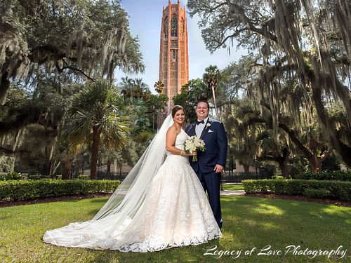 Elegant mature bride with a long veil standing in front of the historic Bok Tower during her second marriage ceremony in Central Florida.