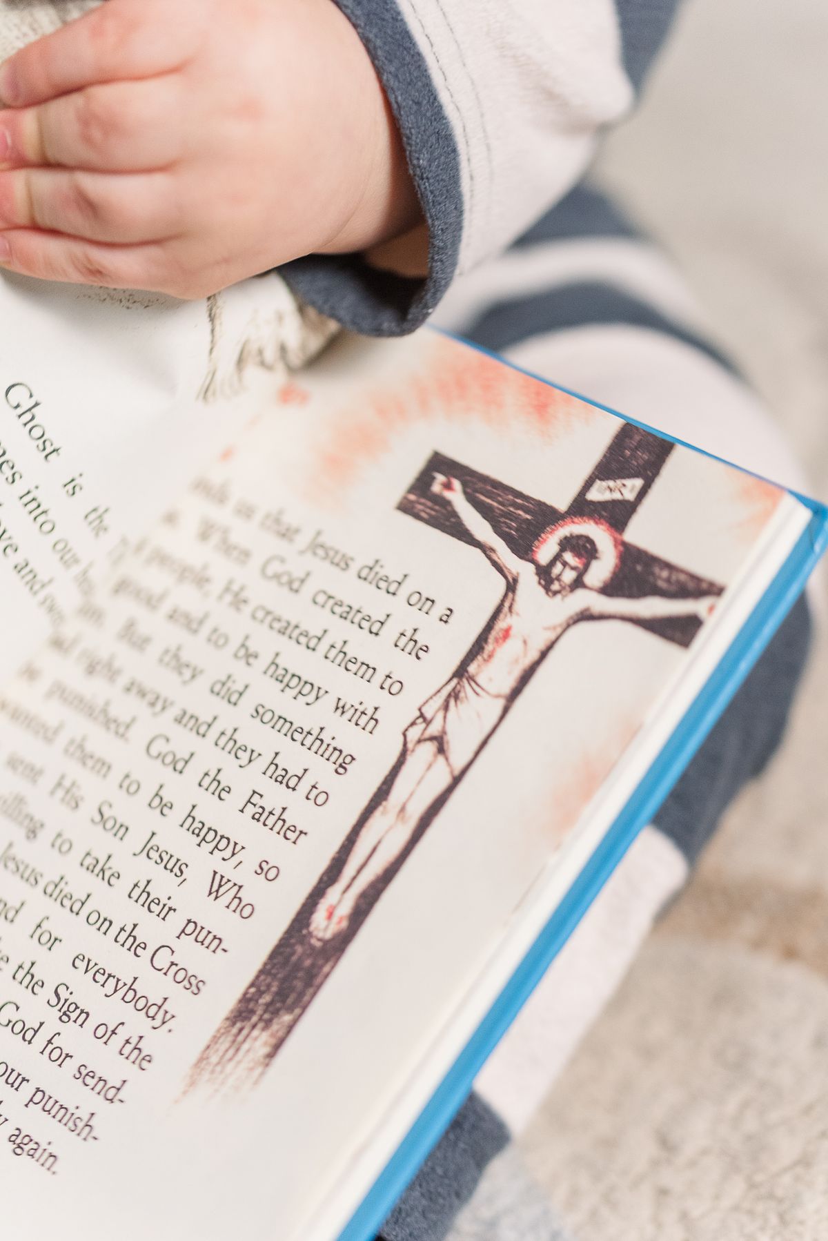 baby hand holding a book about Jesus, in Cranberry Township, PA
