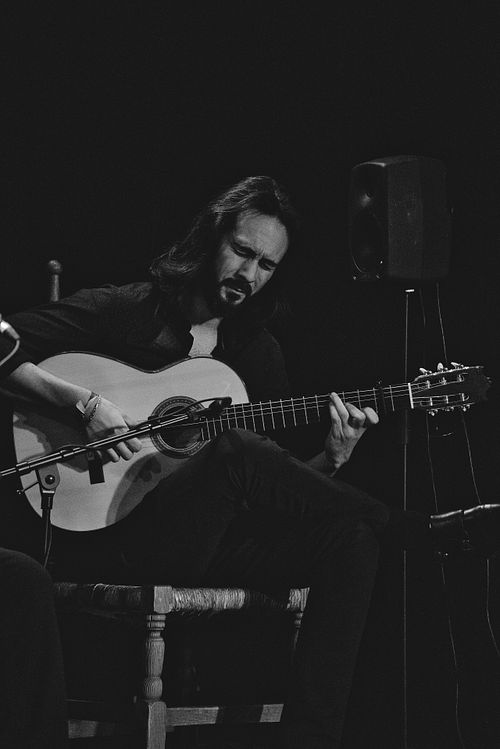 A guitar player playing at a tablao show in Jerez