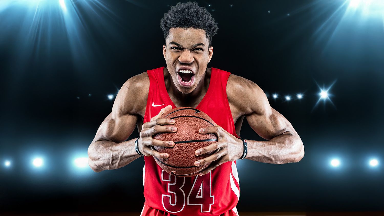 A dramatic studio sports portrait of NBA player Giannis Antetokounmpo in a red Milwaukee Bucks jersey, intensely gripping a basketball against a dark background with cinematic stadium-style backlighting.