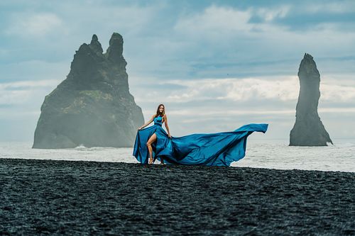 Blue flying dress photoshoot at Reynisfjara beach in south Iceland
