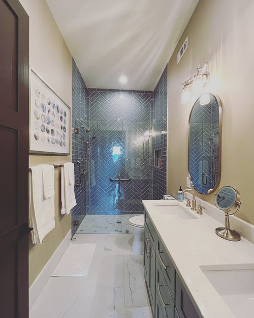 Guest bathroom designed for accessibility, flush shower floor, elegant grab bars, barrier free glass wall partition