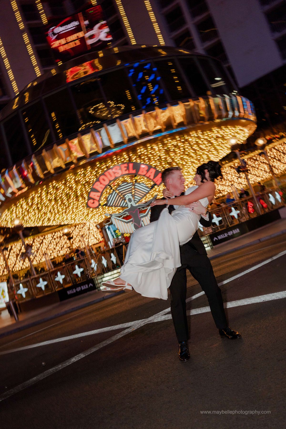 Romantic elopement photos at Carousel Bar in Downtown Las Vegas with couple celebrating with champagne