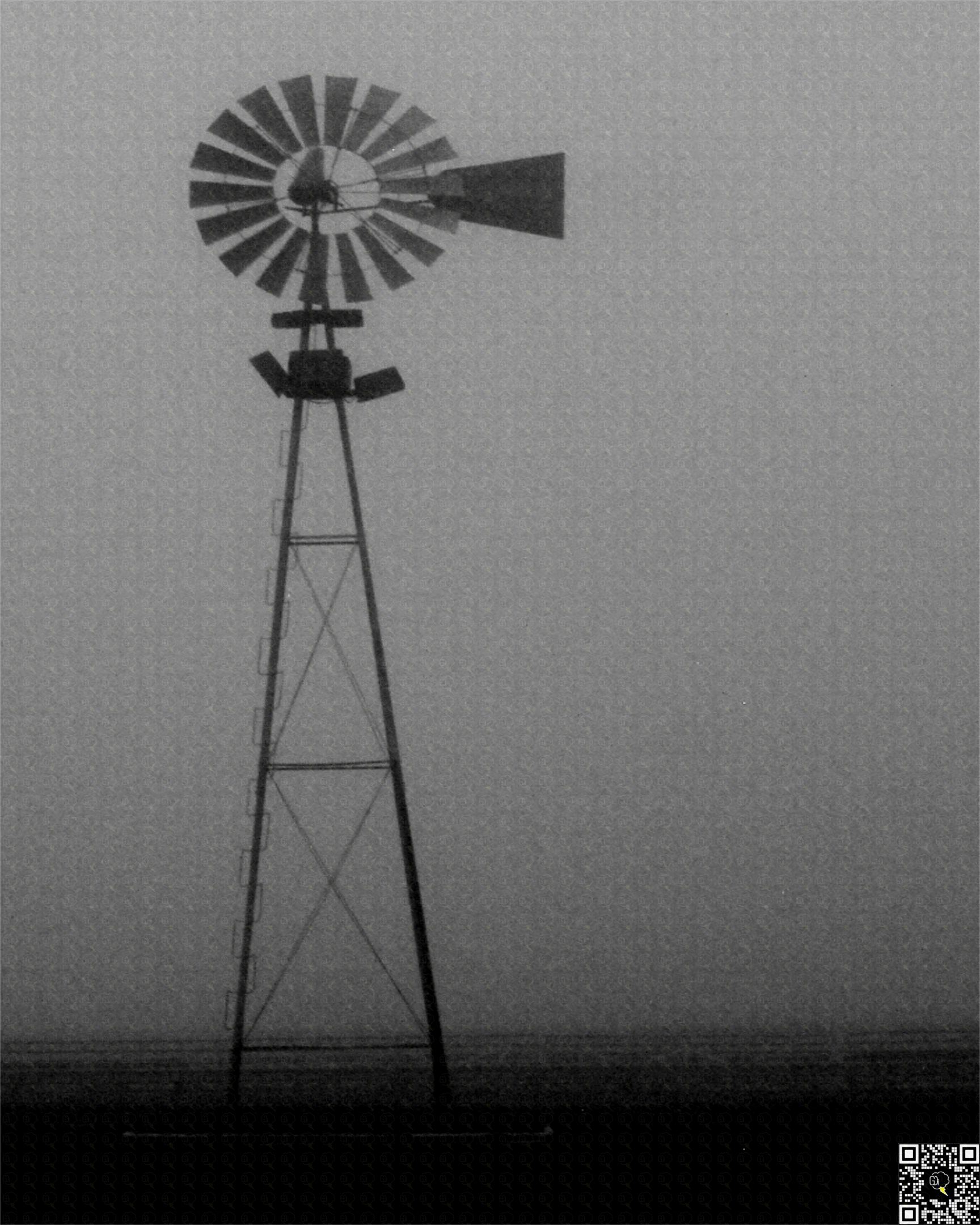 A quiet, still farm surrounded by murky fog.