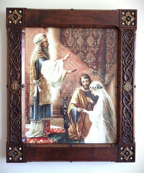 a custom hand-carved picture frame with Icelandic knotwork, shells, and flowers