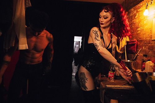 Fire breathing vocalist Clara Fable prepares the fuel for her fire behind the scenes.