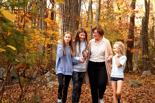 Grandma walks and giggles with her three grand daughters