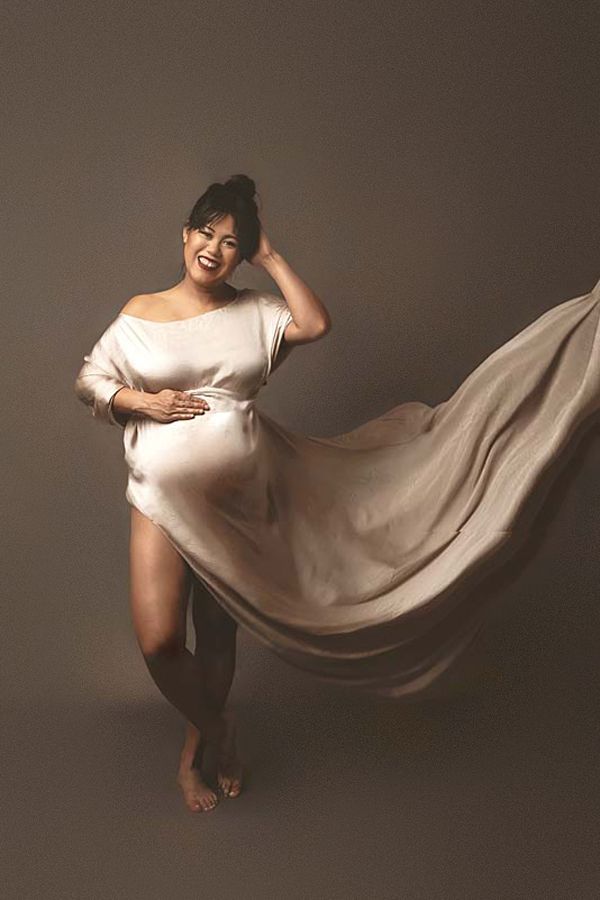 Maternity Photographer In Houston, TX captures fun pregnant lady with fabric thrown