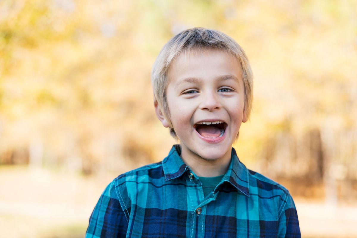 A young man posing for a photograph at Dr. Martin Luther King Jr. Park in Carrboro, NC
