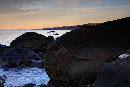 Luminous sky over the rocky coastline.