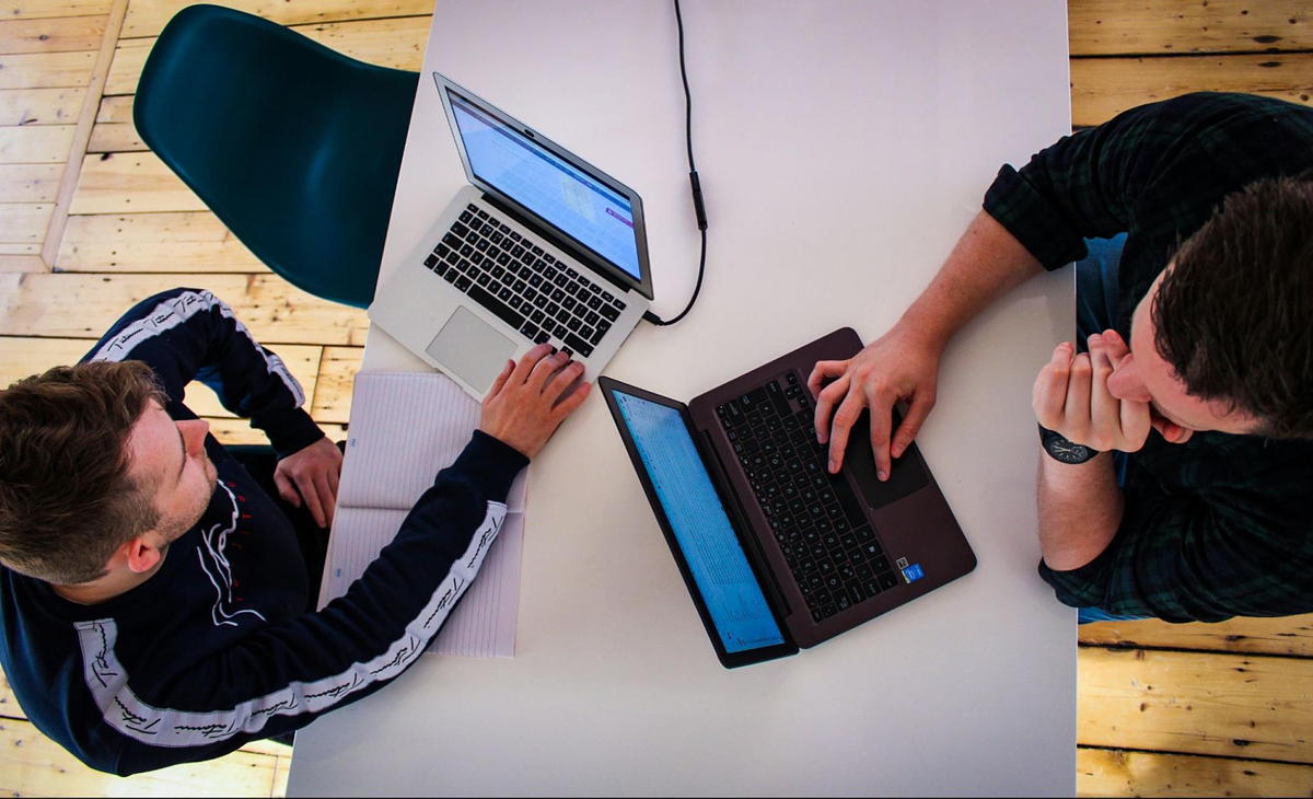 two people on a laptop