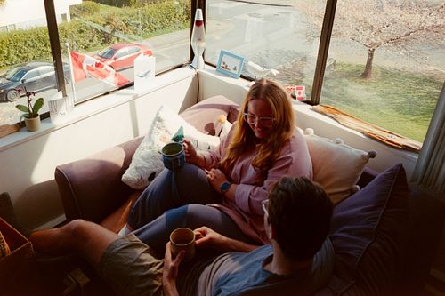 couple drinking tea by their window