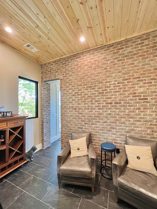 'His' Office off of Man Cave with full-coursed brick wall; built-in pocket door; wood ceiling