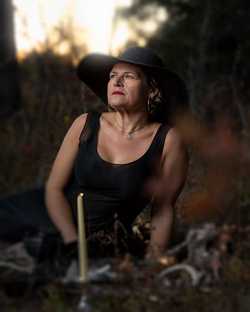 A witch holds a private ritual in the forest.