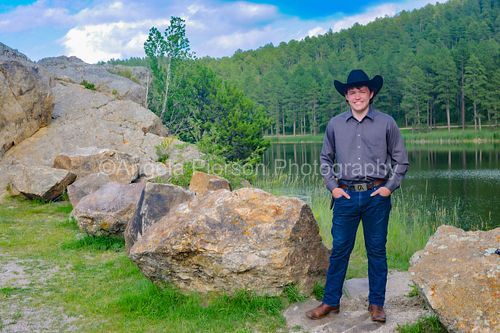 Young man in front of lake