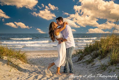 Couple embracing during a surprise beach proposal in Jacksonville by Legacy of Love Photography.