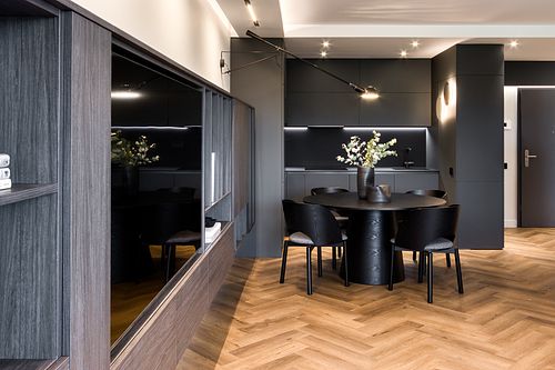 Kitchen and dining area with a dark, moody atmosphere – Azoria project