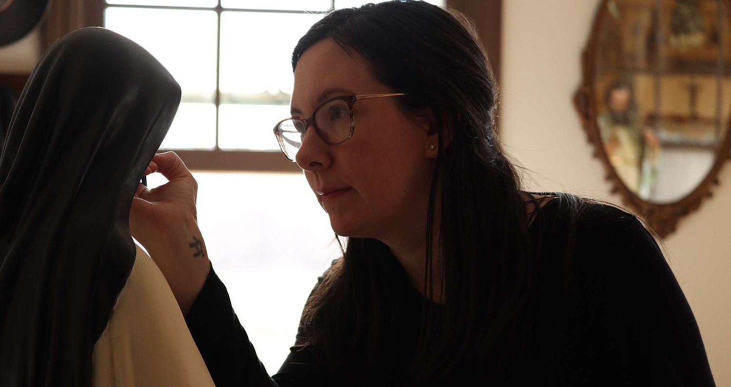 Kelly Baker repainting the face of a beautiful statue of St. Therese of Lisieux for St. Joseph Catholic Church in Somerset, Ohio