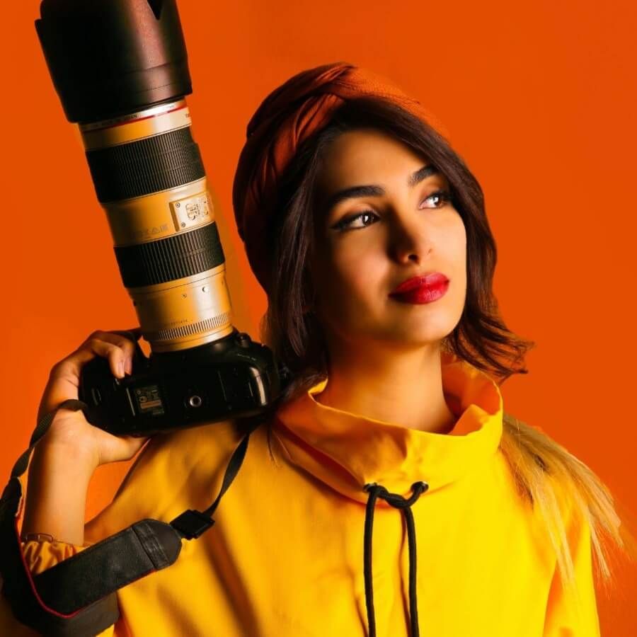 Image of a female photographer posing