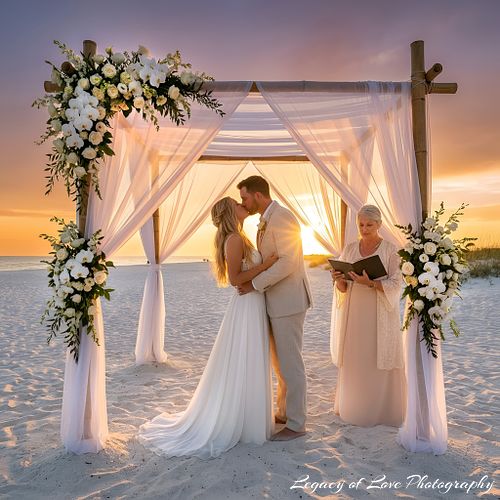 Sunset beach wedding ceremony under a floral arch on Amelia Island by Legacy of Love Photography.