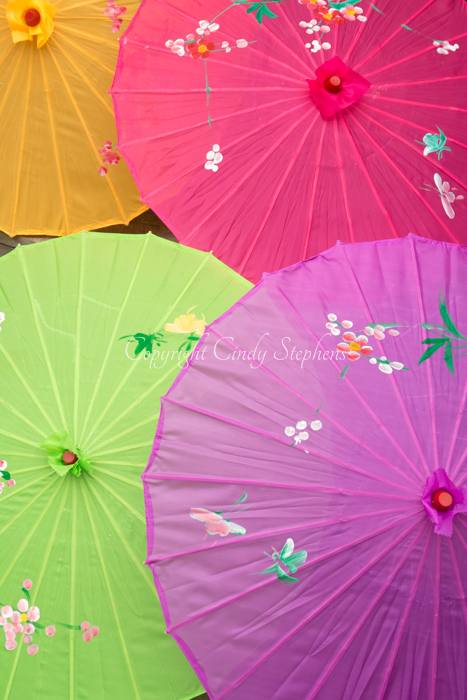 An orange, fuchsia, green and purple parasol
