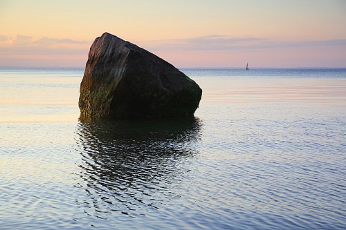 Potter's Rock and sailboat at Landing Beach