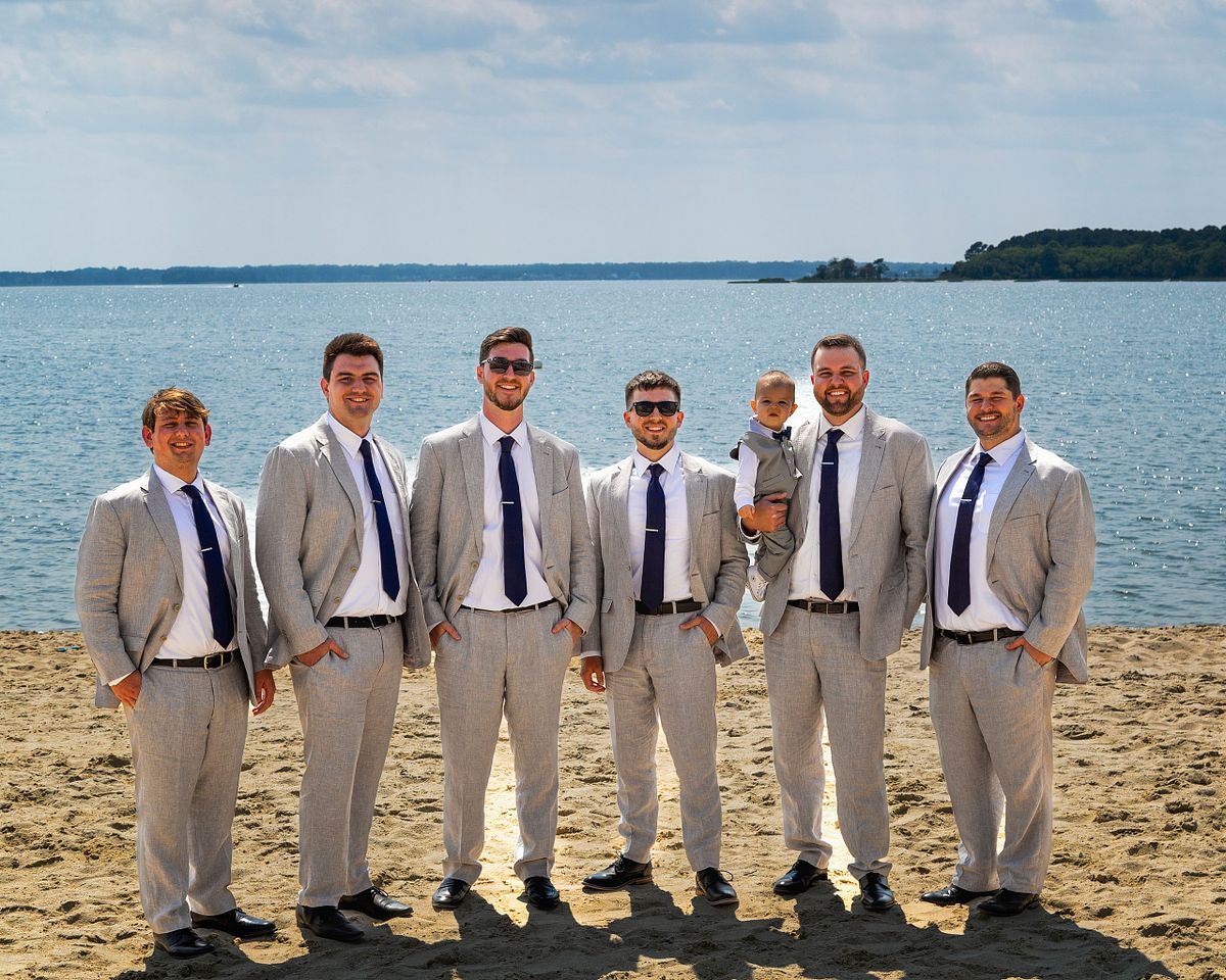 groomsmen and groom posing at the beach in dewey beach, delaware, hyatt