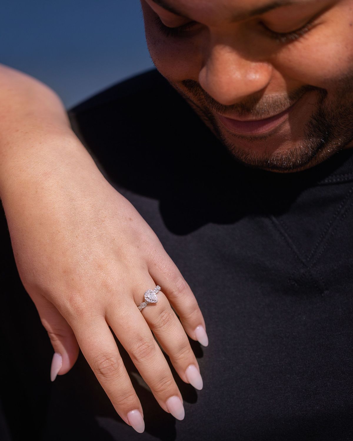 bride showing off her engagement ring during a engagement photography session on the eastern shore in Cape Henlopen