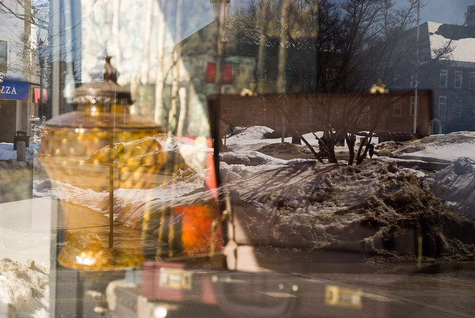 Winter street scene and Massachusetts main street reflected in antique shop window